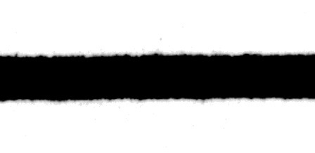 A printed black line whose top and bottom edges spread outward in fine hairs instead of staying crisp — classic bleeding and feathering